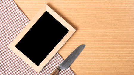 blackboard and knife on tableの写真素材