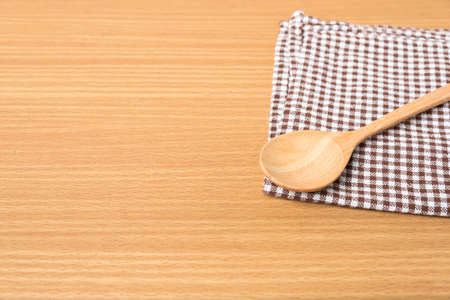 wood spoon and kitchen towel on tableの写真素材