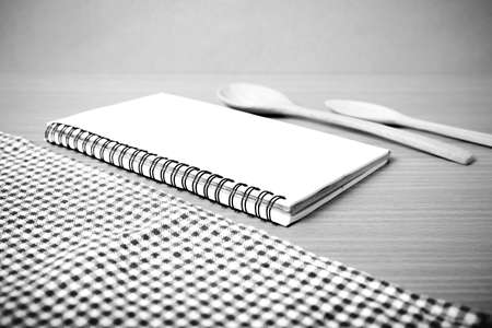 notebook and kitchen tools on table black and white color tone styleの写真素材