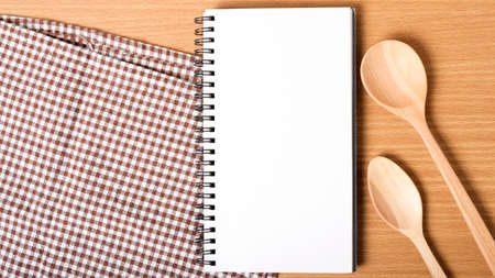 notebook and kitchen tools on tableの写真素材