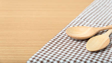 wood spoon and kitchen towel on tableの写真素材