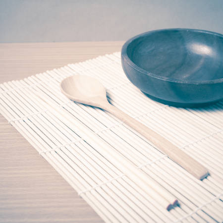 wood spoon bowl and chopstick on mat vintage styleの写真素材