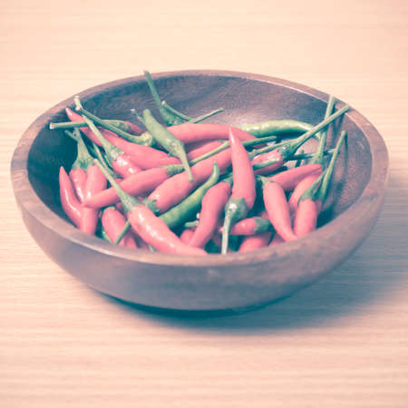 red chili peppers on wood table background vintage styleの写真素材