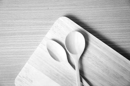 wood spoon with cutting board on table background  black and white color tone styleの写真素材