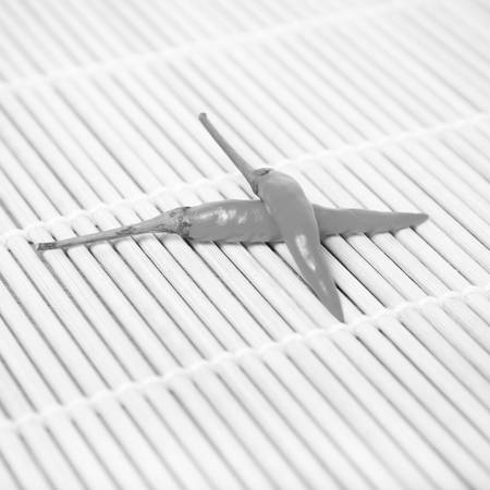 red chili peppers on mat black and white tone color styleの写真素材