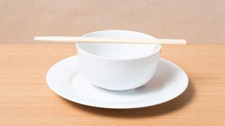 empty bowl with chopstick on wood table backgroundの写真素材