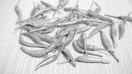 red chili peppers on wood table background black and white tone color styleの写真素材