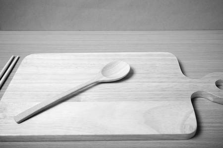 wood spoon with cutting board on table background black and white color tone styleの写真素材