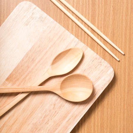 wood spoon with cutting board on table backgroundの写真素材