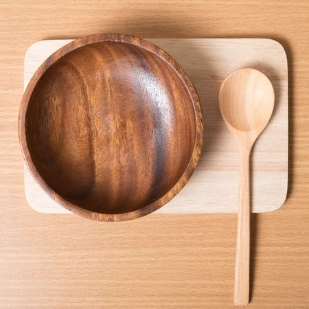 wood bowl and spoon on table backgroundの写真素材