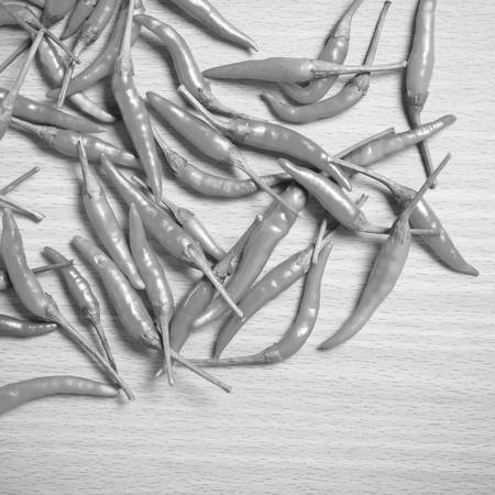 red chili peppers on wood table background black and white tone color styleの写真素材