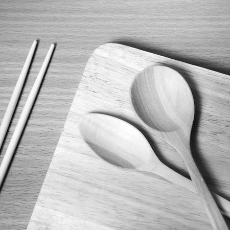 wood spoon with cutting board on table background black and white color tone styleの写真素材