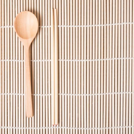 wood spoon and chopstick on matの写真素材