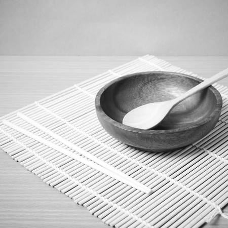 empty bowl with chopstick on wood table background black and white color tone styleの写真素材