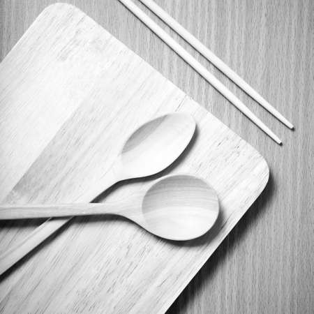 wood spoon with cutting board on table background black and white color tone styleの写真素材