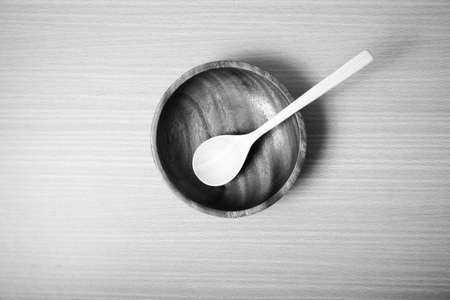wood bowl and spoon on table background black and white color tone styleの写真素材