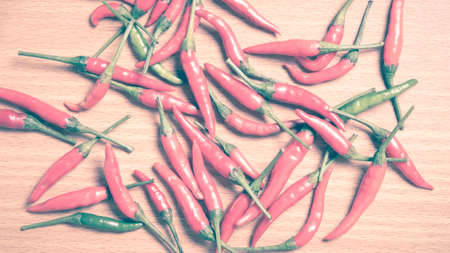 red chili peppers on wood table background vintage styleの写真素材