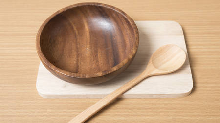 wood bowl and spoon on table backgroundの写真素材