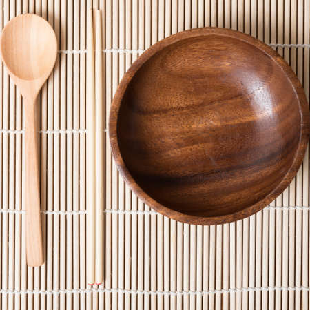 wood spoon bowl and chopstick on matの写真素材