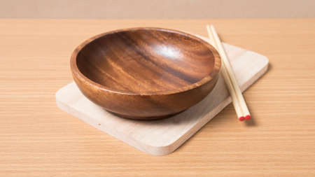 empty bowl with chopstick on wood table backgroundの写真素材