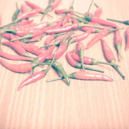red chili peppers on wood table background vintage styleの写真素材
