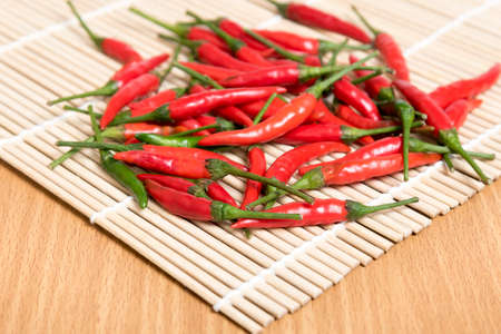 red chili peppers on wood table backgroundの写真素材