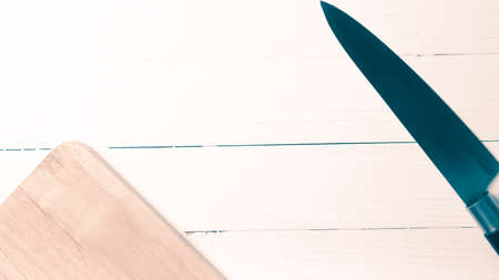 kitchen knife on cutting board over table background vintage styleの写真素材