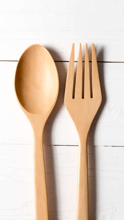 wood spoon and fork over white table backgroundの写真素材