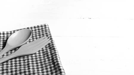 wood spoon and fork on kitchen towel over background black and white tone color styleの写真素材