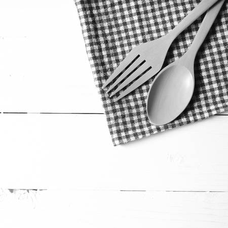 wood spoon and fork on kitchen towel over background black and white tone color style