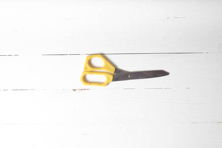 scissors over white table backgroundの写真素材