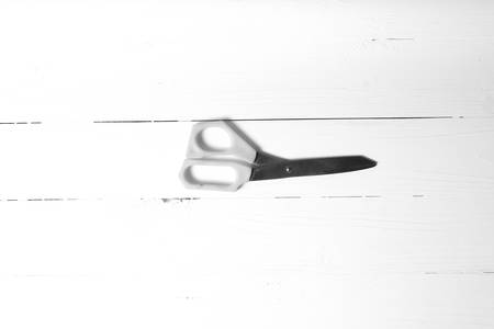 scissors over table background black and white tone color styleの写真素材