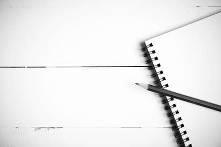 pencil and notepad on white table view from above black and white color styleの写真素材