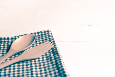 wood spoon and fork on kitchen towel over background vintage styleの写真素材