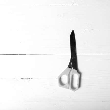 scissors over table background black and white tone color styleの写真素材