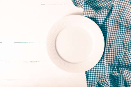 empty dish with kitchen towel over table background vintage styleの写真素材