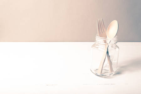 wood spoon and fork with glass over table vintage styleの写真素材