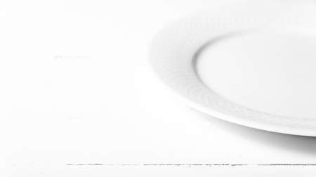 empty dish over white table background black and white tone color styleの写真素材