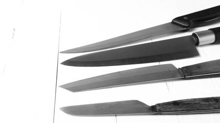 kitchen knife over table background black and white tone color styleの写真素材