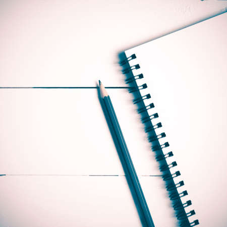 pencil and notepad on white table view from above vintage styleの写真素材