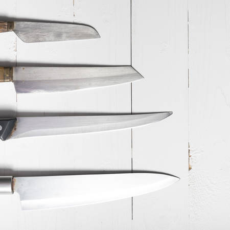 kitchen knife over white table backgroundの写真素材