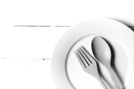 wood spoon and fork with dish over table background black and white tone color styleの写真素材