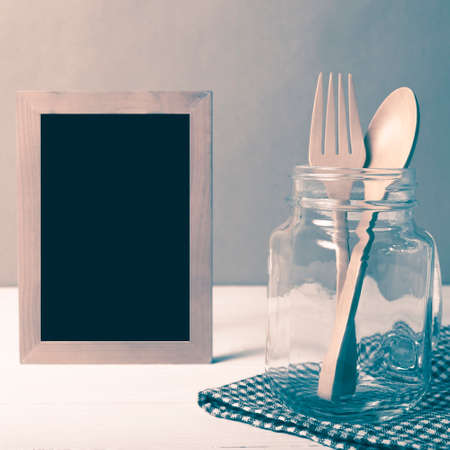 wood spoon and fork with glass over table vintage styleの写真素材