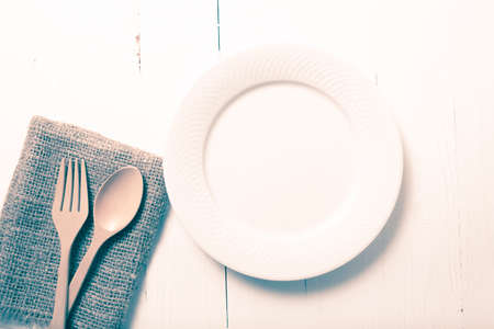 wood spoon and fork with dish over table background vintage styleの写真素材