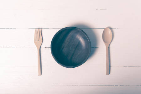 wood spoon and fork with bowl on vintage styleの写真素材