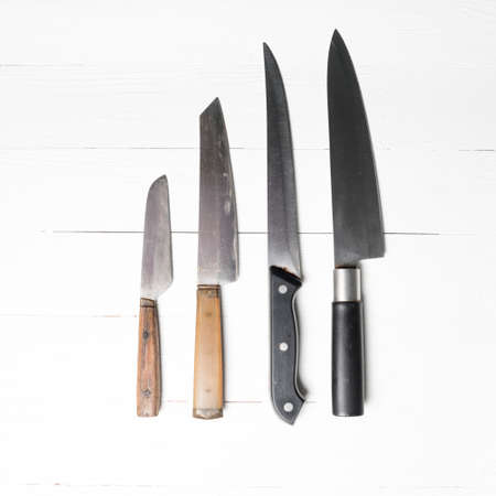 kitchen knife over white table backgroundの写真素材