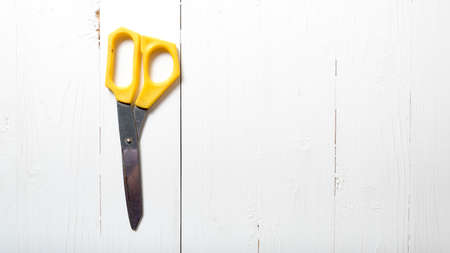 scissors over white table backgroundの写真素材