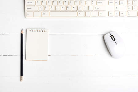 notepad and computer on white table background view from aboveの写真素材