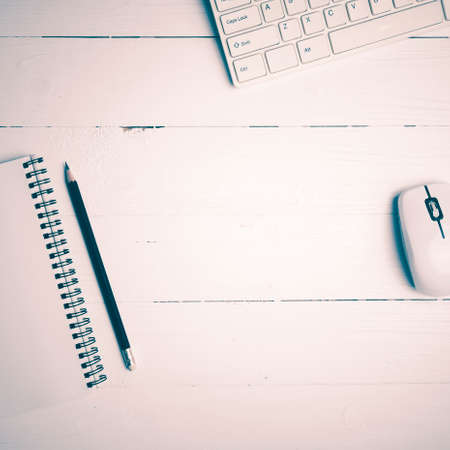 notepad and computer on white table background view from above vintage style