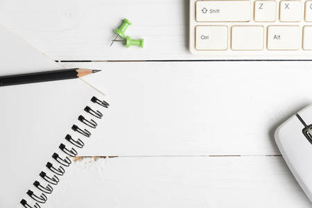 notepad and computer on white table background view from aboveの写真素材